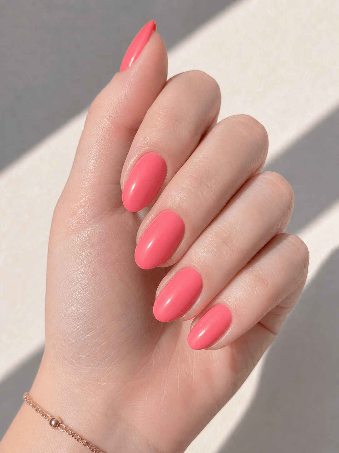 Pink-coral nails on cool undertone skin