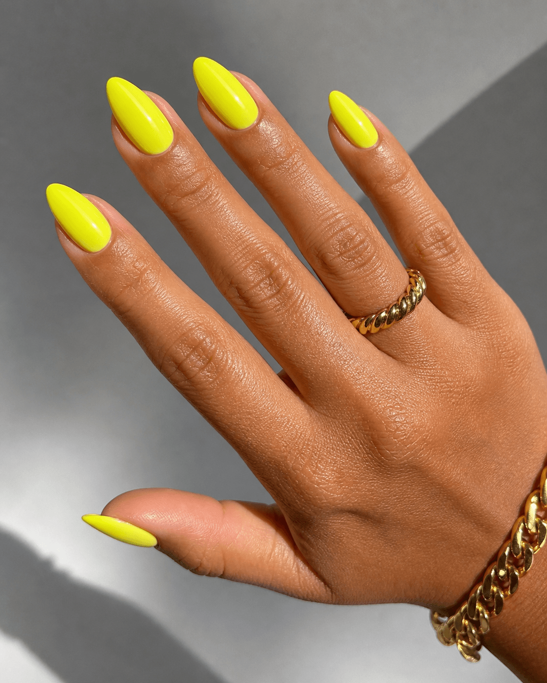 Neon yellow nails on warm medium skin