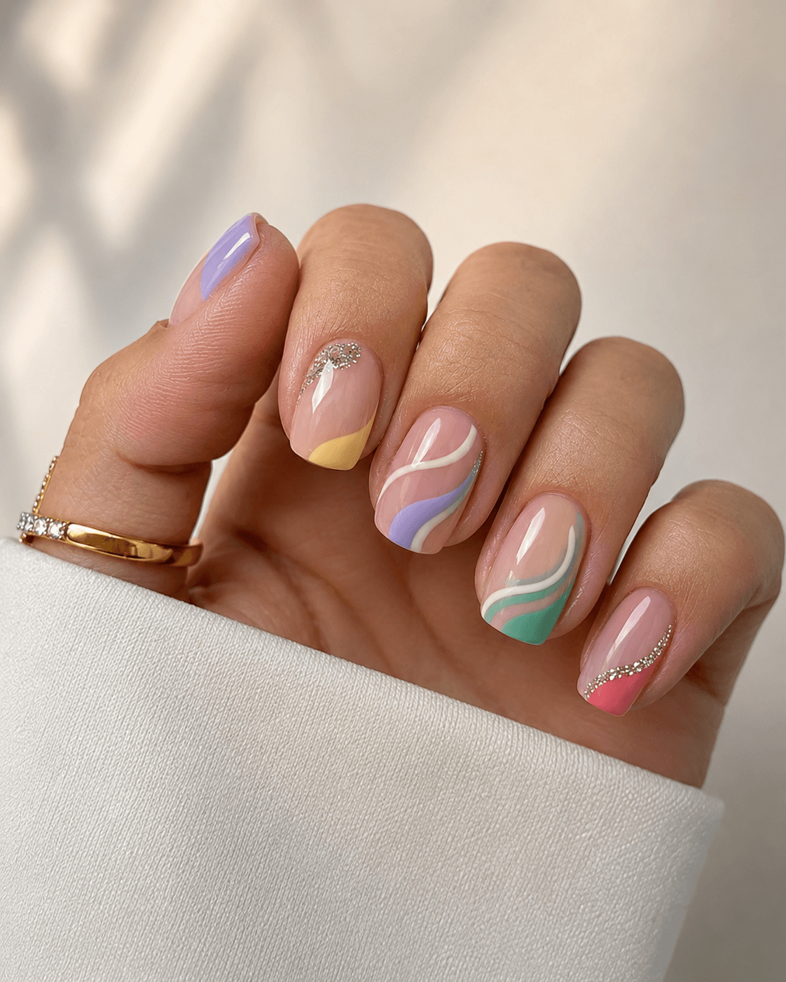 Abstract pastel swirl nails with glitter French accents