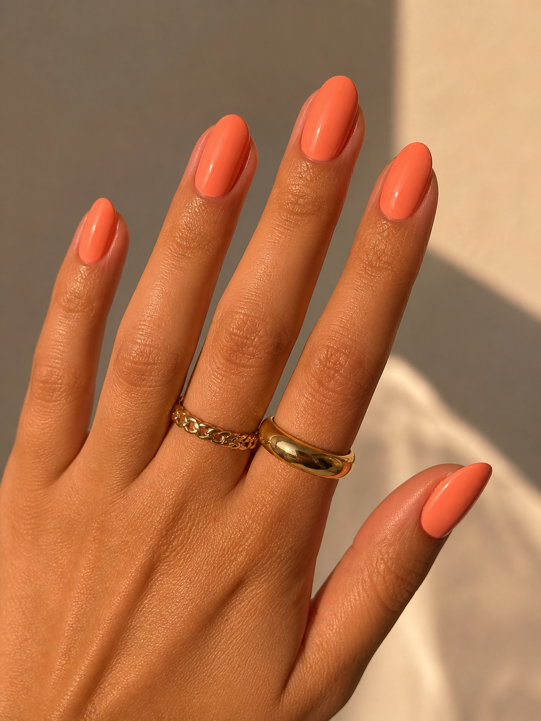 Coral nails on warm undertone skin