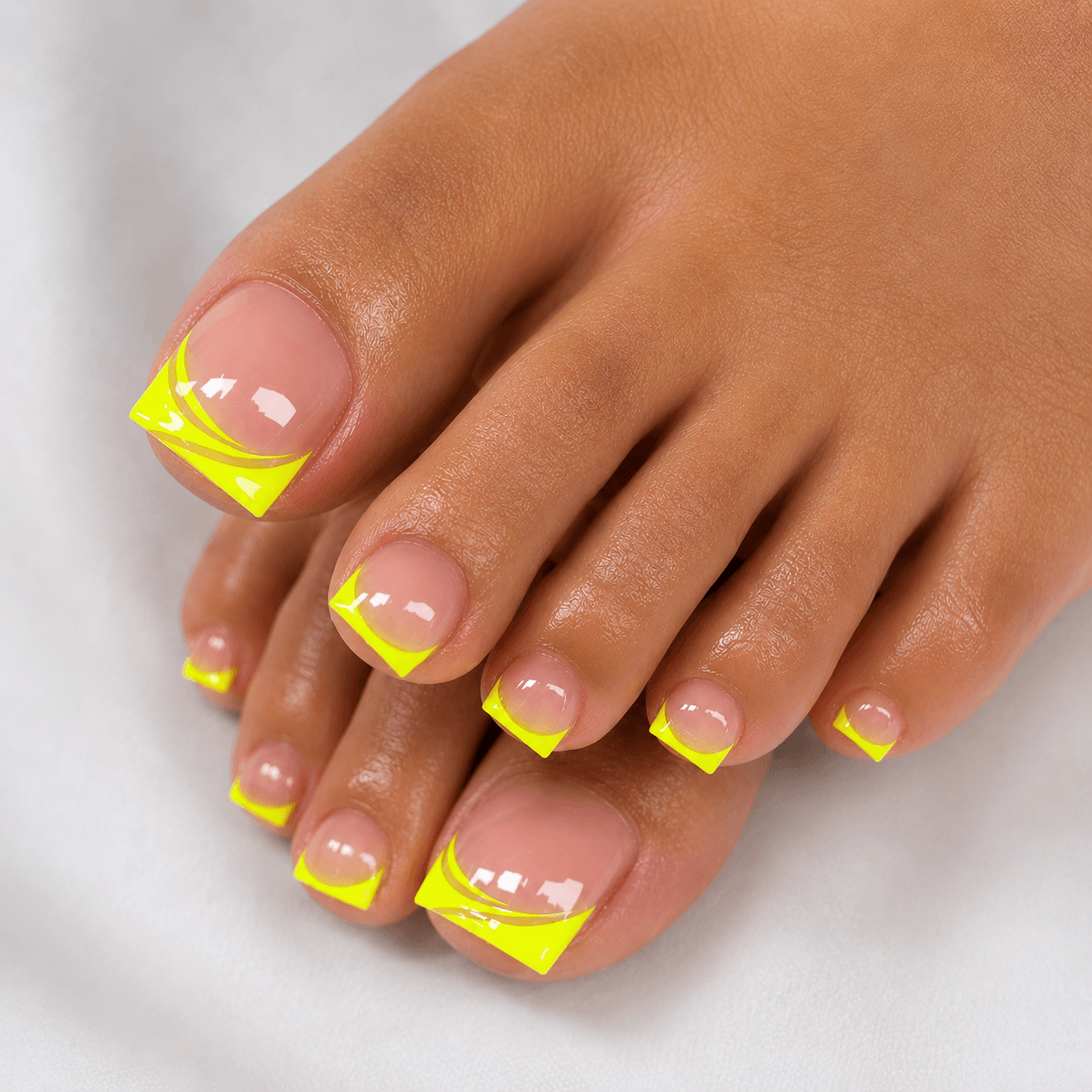 Macro close-up of glossy neon coral pedicure on short square toenails in bright outdoor sunlight with soft natural shadows.