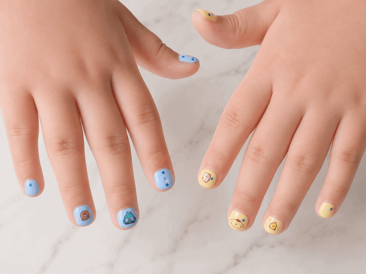 Close-up of children's nails painted in pastel blue and yellow with cute cartoon character nail stickers