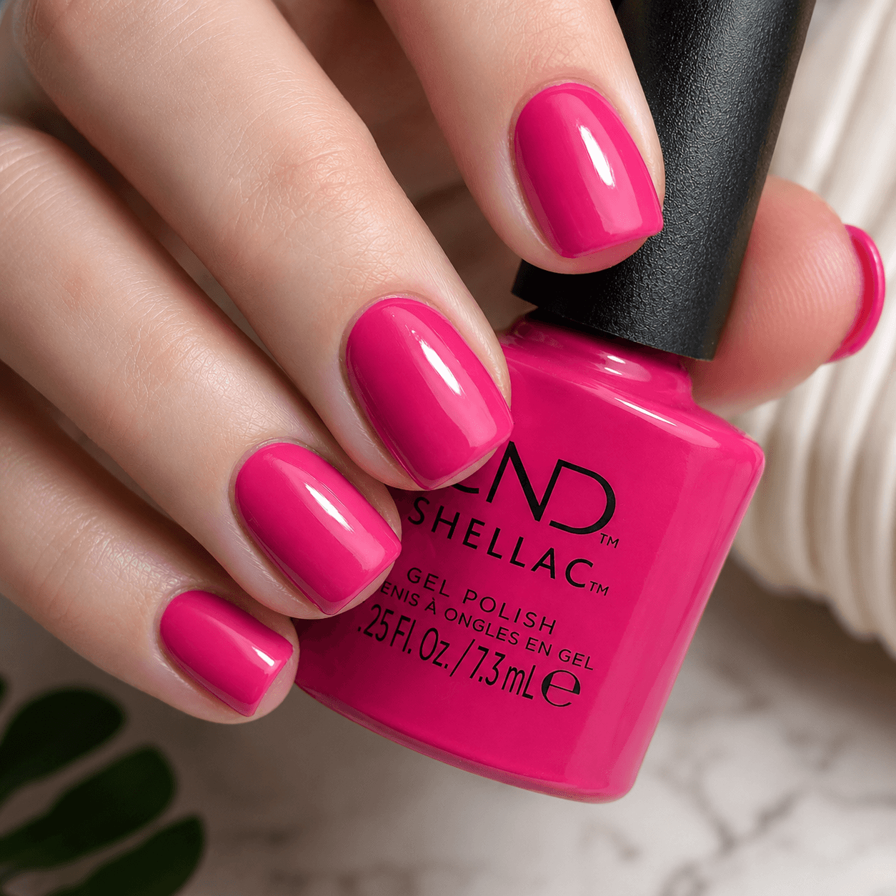Close-up of vibrant hot pink Shellac gel nails